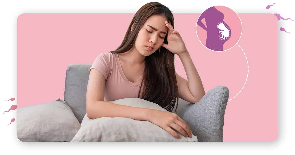 Understand first month pregancy symptom-girl sitting in sofa with pillow